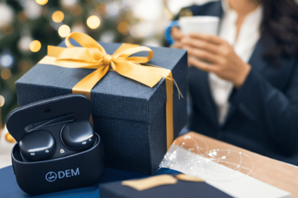 Business professionals exchanging customized tech products including OEM earbuds and accessories for corporate gifting